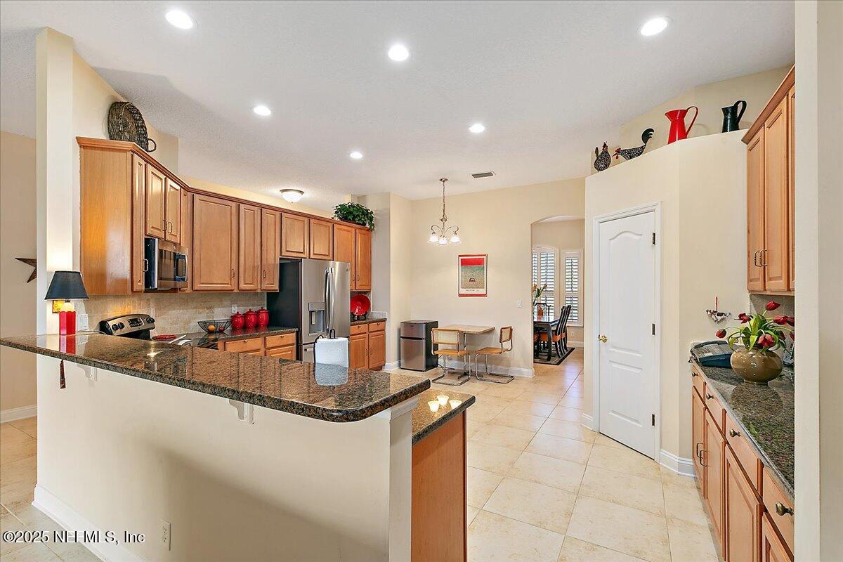 4907 Reed Island Trail Jacksonville, FL 32225 - Photo 8 of 25 a kitchen with stainless steel appliances granite countertop a sink refrigerator and cabinets