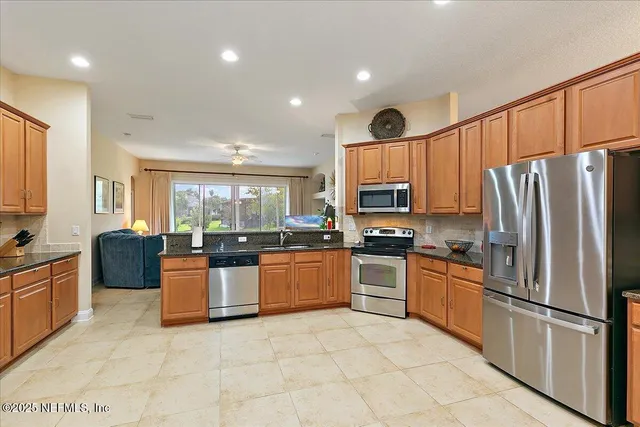 a kitchen with stainless steel appliances a refrigerator and a refrigerator