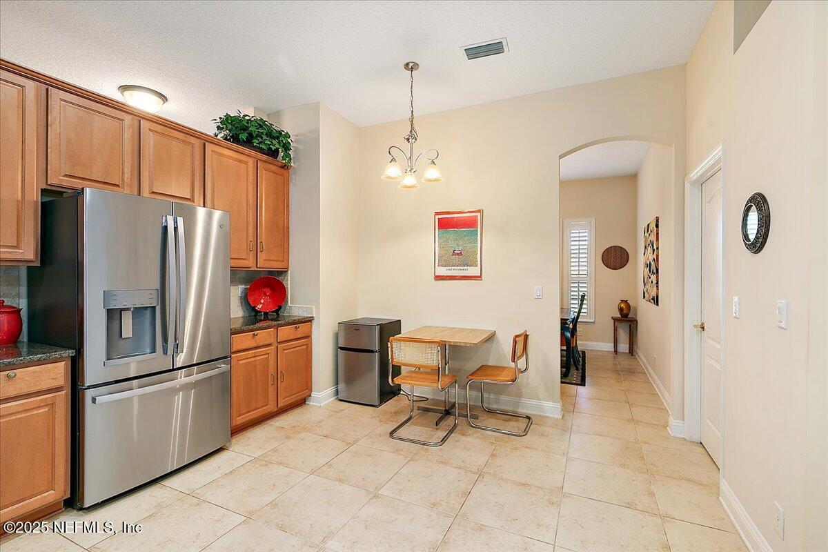 4907 Reed Island Trail Jacksonville, FL 32225 - Photo 10 of 25 a kitchen with stainless steel appliances a refrigerator and a refrigerator