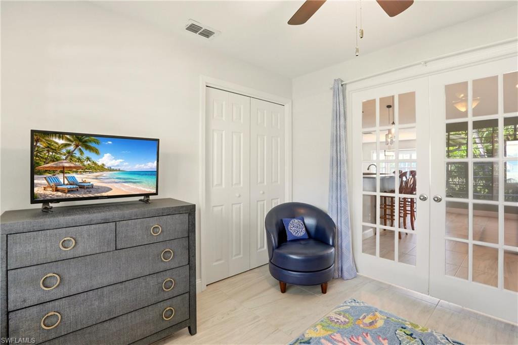 4282 Longshore Way North Naples, FL 34119 - Photo 17 of 43 Living area with french doors and ceiling fan