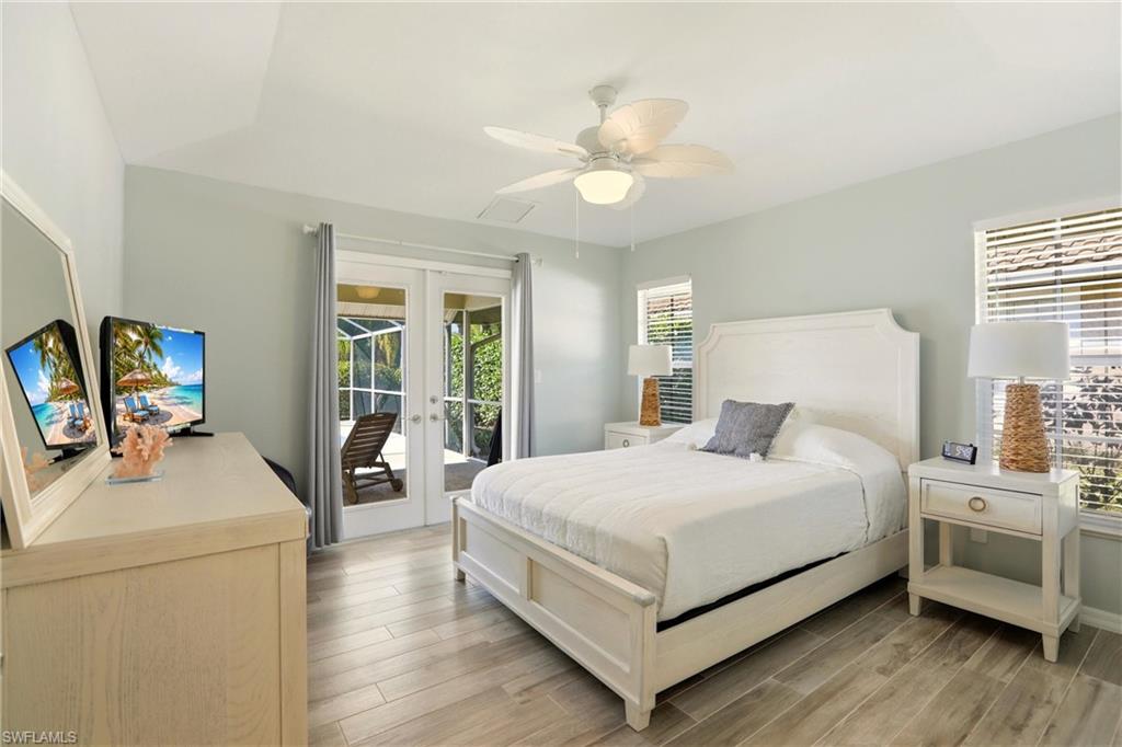 4282 Longshore Way North Naples, FL 34119 - Photo 19 of 43 Bedroom featuring french doors, light wood-style floors, access to exterior, and ceiling fan