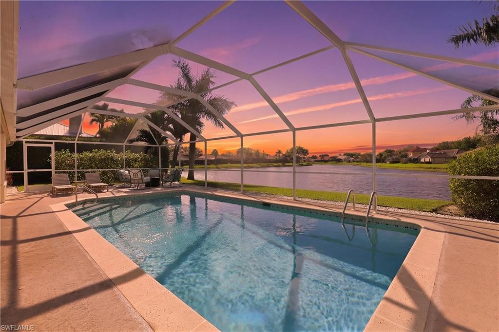 4282 Longshore Way North Naples, FL 34119 - Photo 2 of 43 Outdoor pool with glass enclosure, a sunroom, a water view, a patio, and a residential view