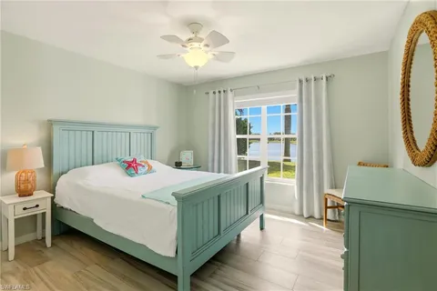 a bedroom with a bed a dresser and a window
