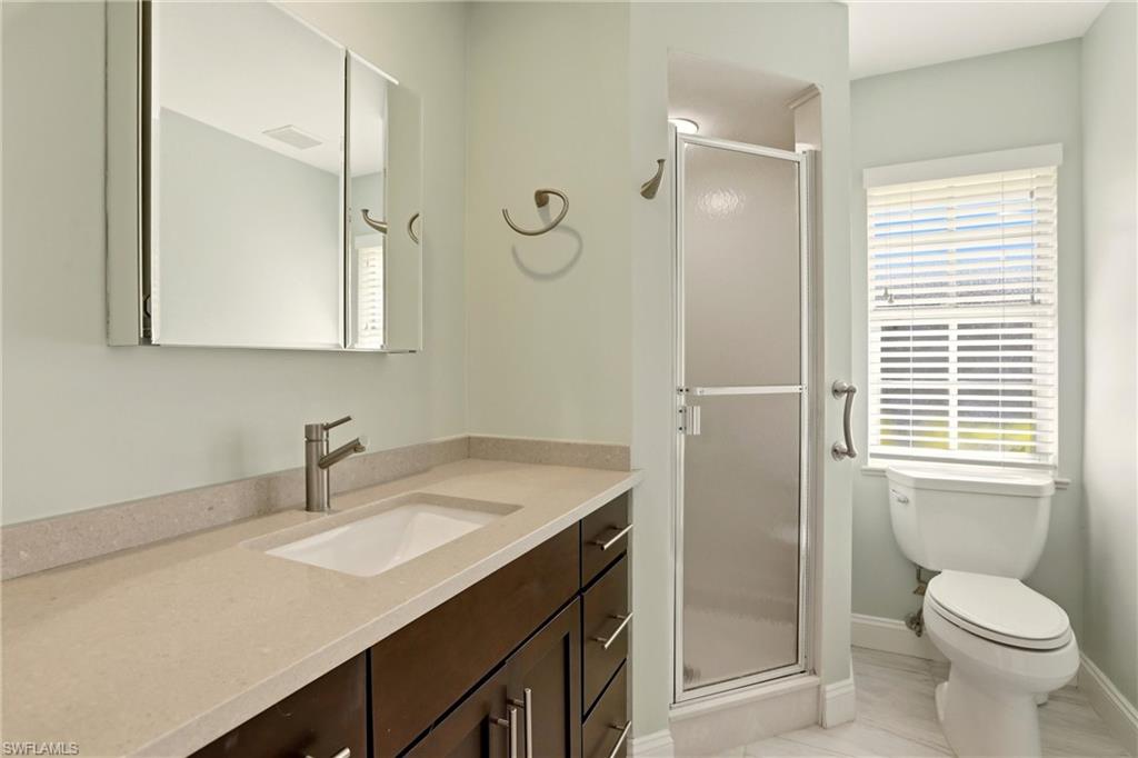 4282 Longshore Way North Naples, FL 34119 - Photo 26 of 43 Bathroom featuring a stall shower and vanity