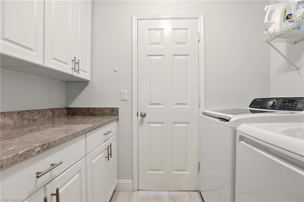 4282 Longshore Way North Naples, FL 34119 - Photo 28 of 43 Laundry room featuring cabinet space and separate washer and dryer