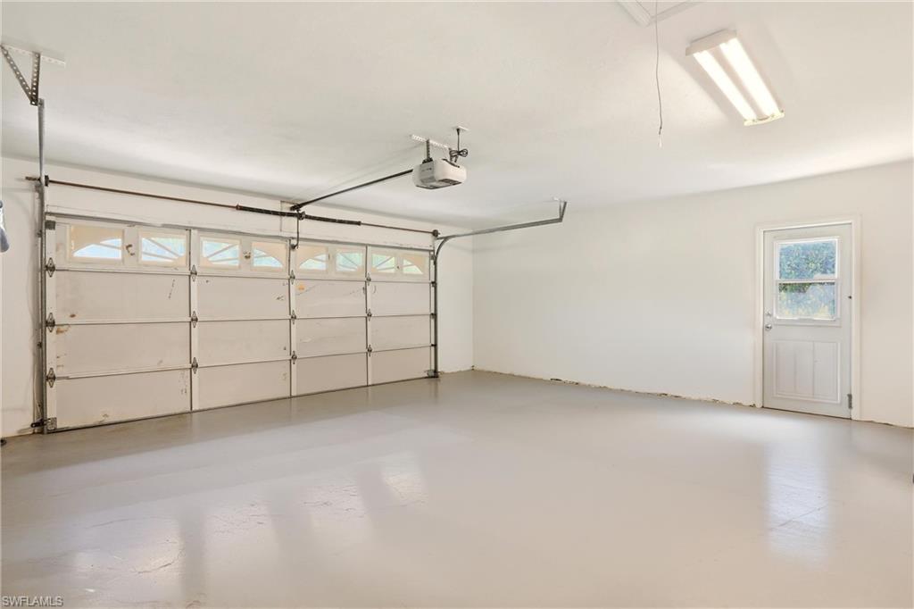 4282 Longshore Way North Naples, FL 34119 - Photo 29 of 43 Garage featuring a garage door opener