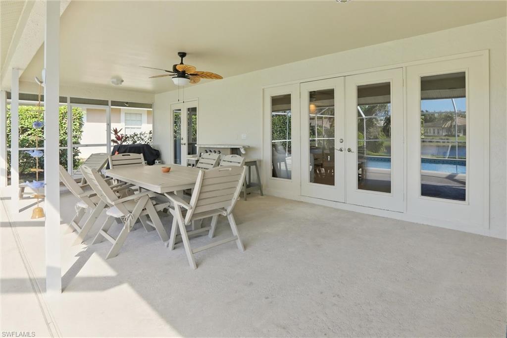 4282 Longshore Way North Naples, FL 34119 - Photo 30 of 43 View of patio / terrace featuring french doors, a ceiling fan, and outdoor dining space