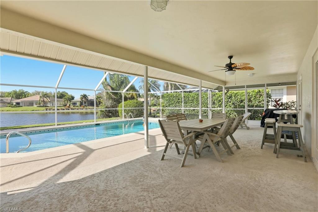 4282 Longshore Way North Naples, FL 34119 - Photo 33 of 43 Swimming pool featuring a patio area, a lanai, a sunroom, outdoor dining space, and a residential view