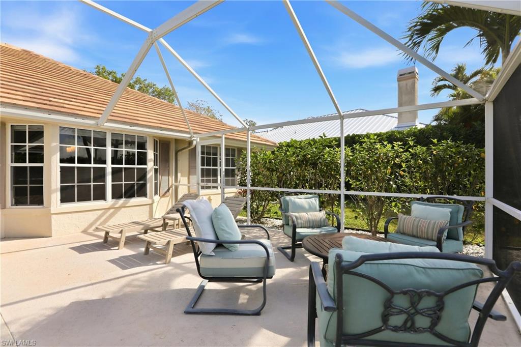 4282 Longshore Way North Naples, FL 34119 - Photo 34 of 43 View of patio with a sunroom, a lanai, and outdoor furniture