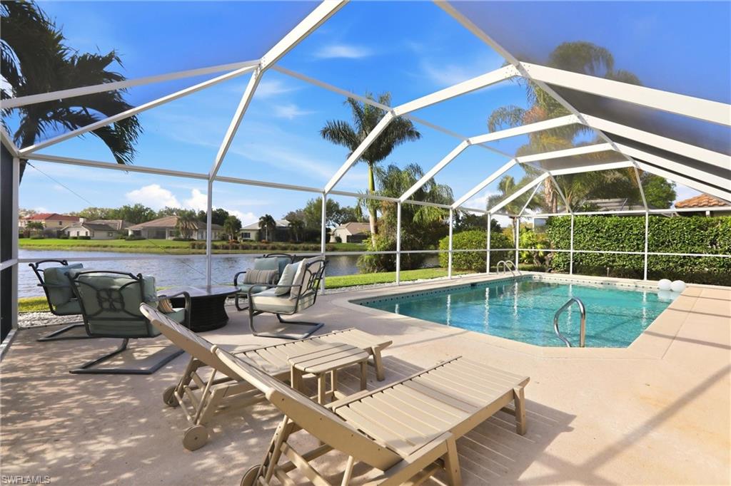 4282 Longshore Way North Naples, FL 34119 - Photo 36 of 43 Swimming pool with a sunroom, a residential view, a patio area, a lanai, and a water view