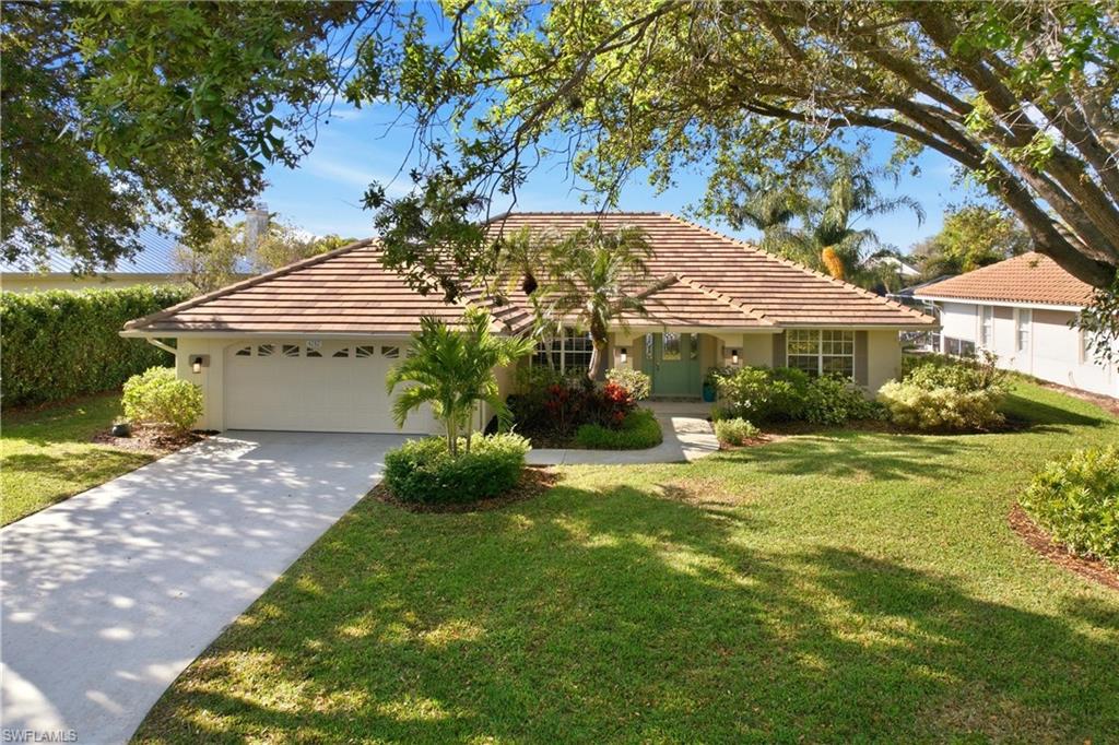 4282 Longshore Way North Naples, FL 34119 - Photo 38 of 43 Ranch-style home featuring a garage, a tiled roof, and a front yard