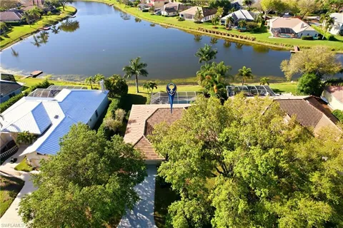 an aerial view of residential houses with swimming pool and outdoor space