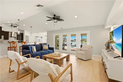 a living room with lots of furniture and a flat screen tv