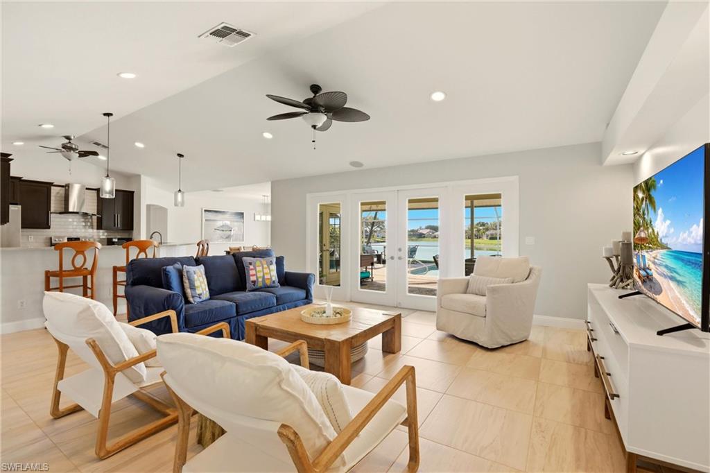 4282 Longshore Way North Naples, FL 34119 - Photo 5 of 43 Living room with a ceiling fan, french doors, recessed lighting, and vaulted ceiling