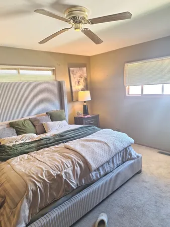 a bedroom with a bed and window