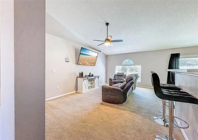 a view of a livingroom with furniture and a window