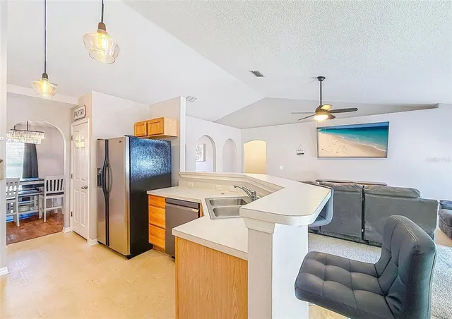 a kitchen with stainless steel appliances kitchen island granite countertop a stove and a sink