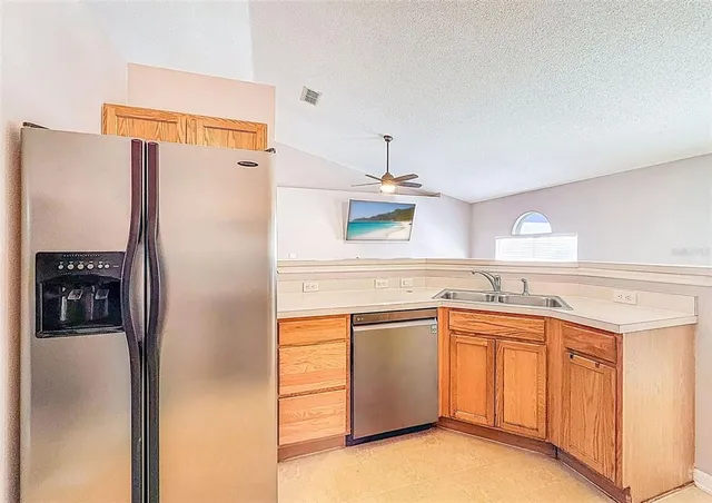 a kitchen with stainless steel appliances a stove a sink and a microwave