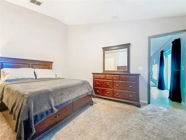 a bedroom with a bed and a dresser