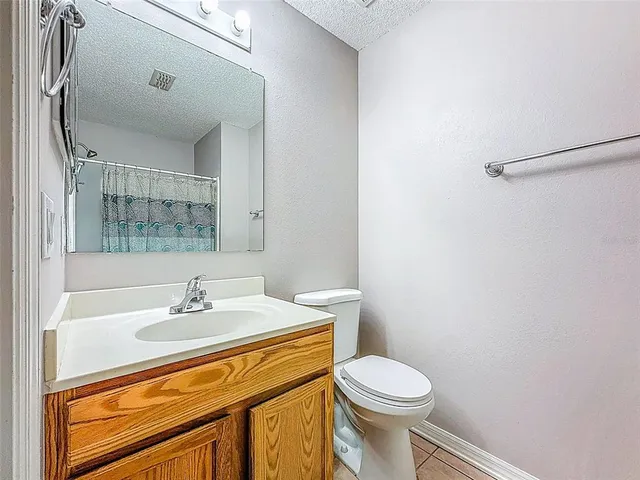 a view of a hallway with furniture and a chandelier