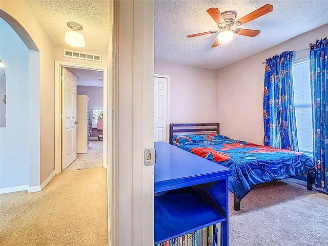 a bedroom with a bed and a television