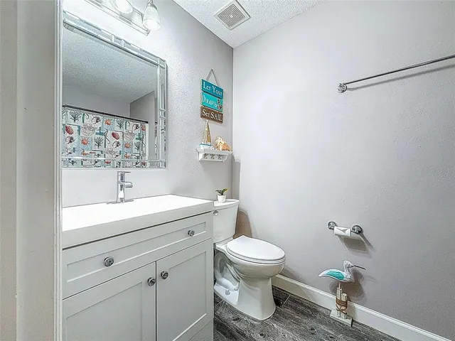 a view of a house with backyard and trees