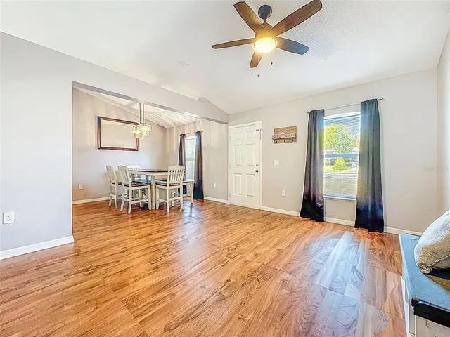 a room with wooden floor and a ceiling fan