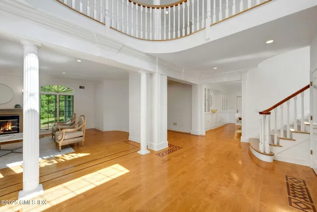 a view of a livingroom with furniture and staircase