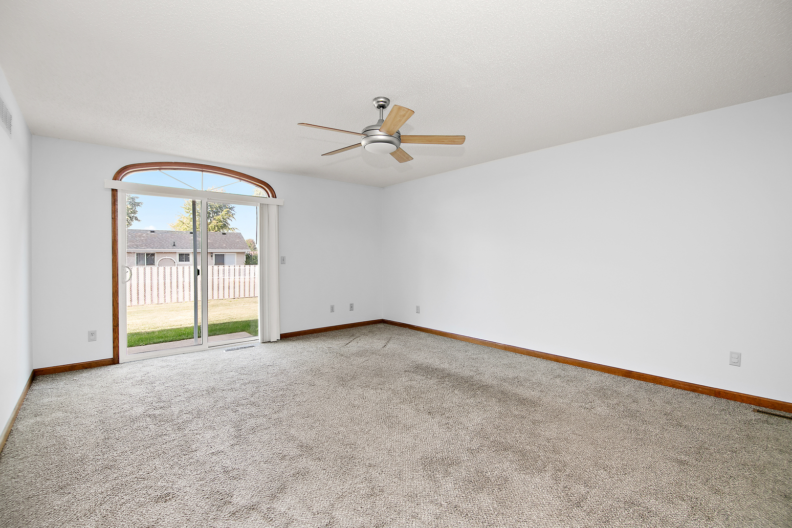 1372 Armour Road, Unit 1372 Bourbonnais, IL 60914 - Photo 4 of 15 an empty room with chandelier fan and windows