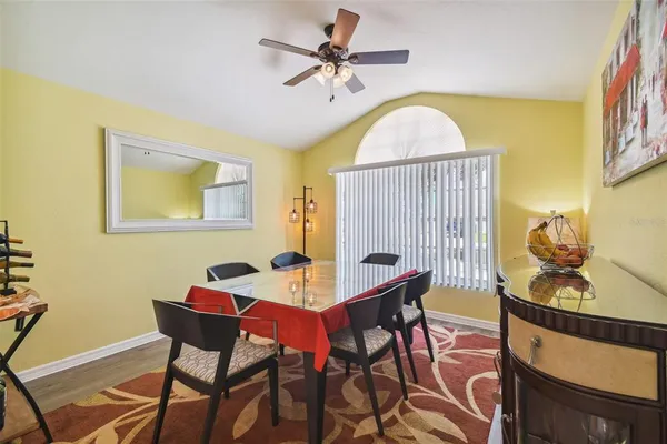 a view of a dining room with furniture and a chandelier