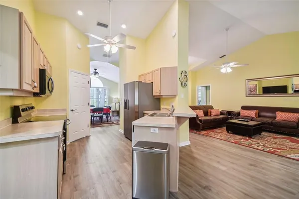 a kitchen with a stove a refrigerator and a sink