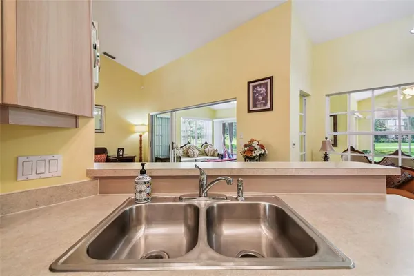 a kitchen with a sink and wooden floor