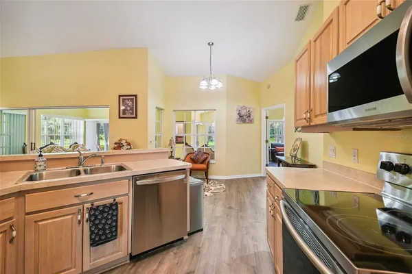 a kitchen with a sink appliances and cabinets