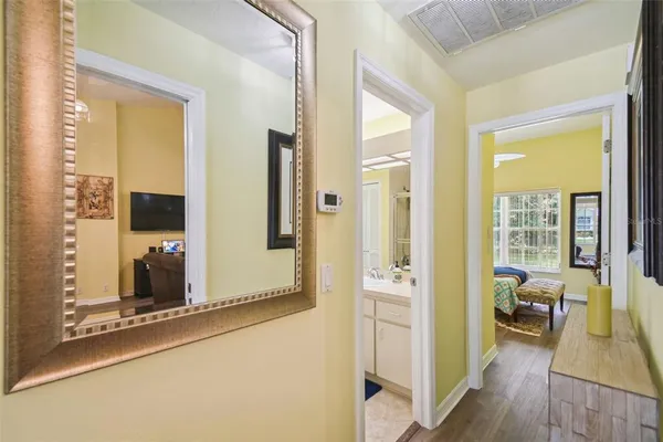 a view of a hallway with wooden floor and staircase