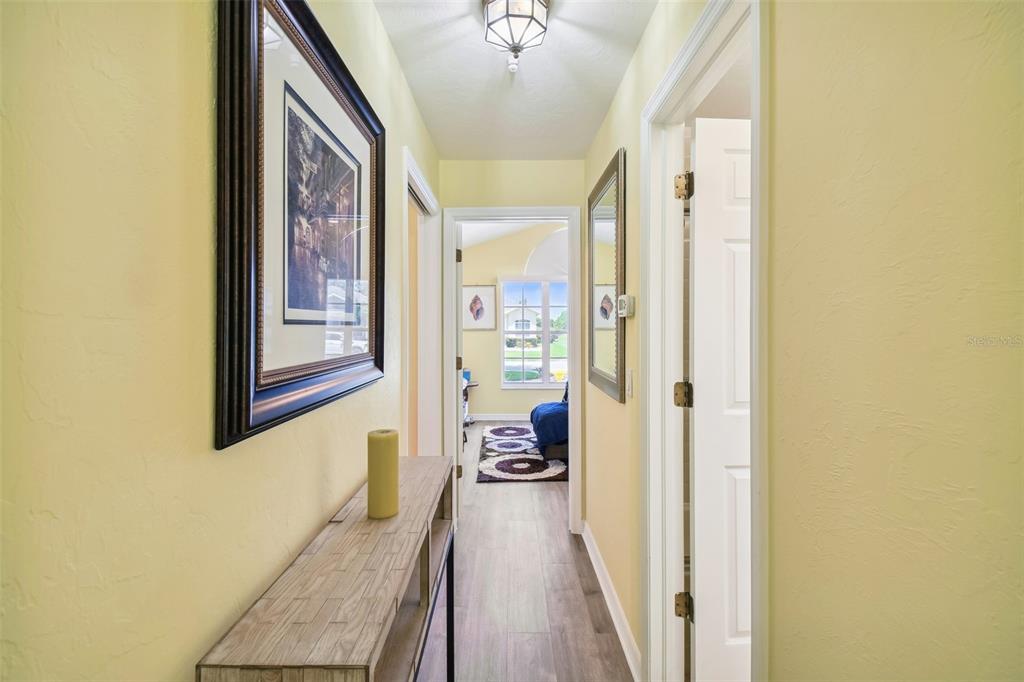 12728 Flamingo Parkway Spring Hill, FL 34610 - Photo 21 of 54 a view of a hallway with wooden floor and staircase