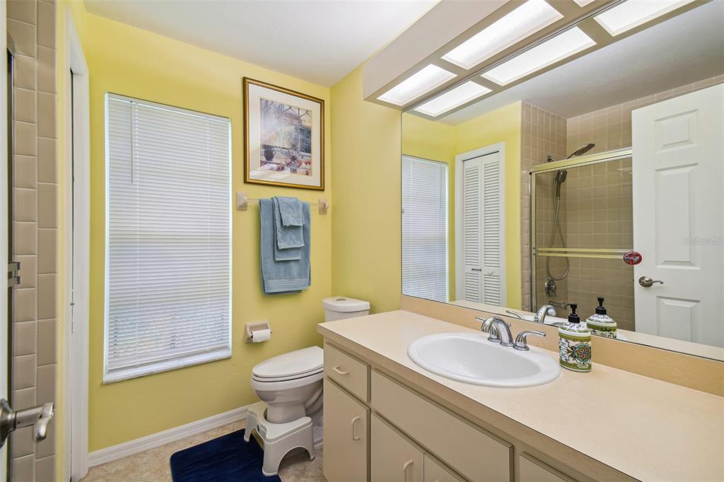 12728 Flamingo Parkway Spring Hill, FL 34610 - Photo 22 of 54 a bathroom with a granite countertop sink toilet and shower