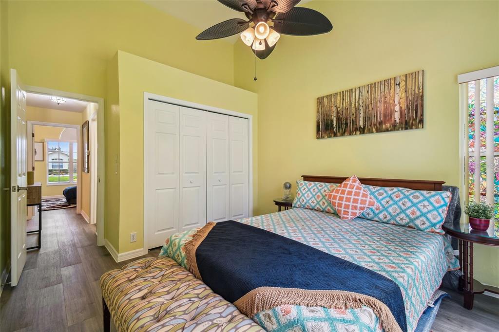 12728 Flamingo Parkway Spring Hill, FL 34610 - Photo 26 of 54 a bedroom with a bed and a chandelier