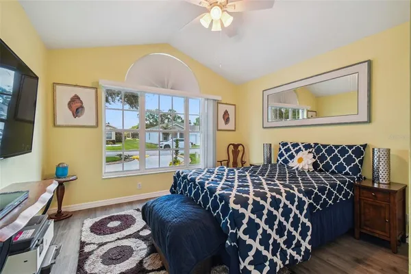 a bedroom with a bed and wooden floor