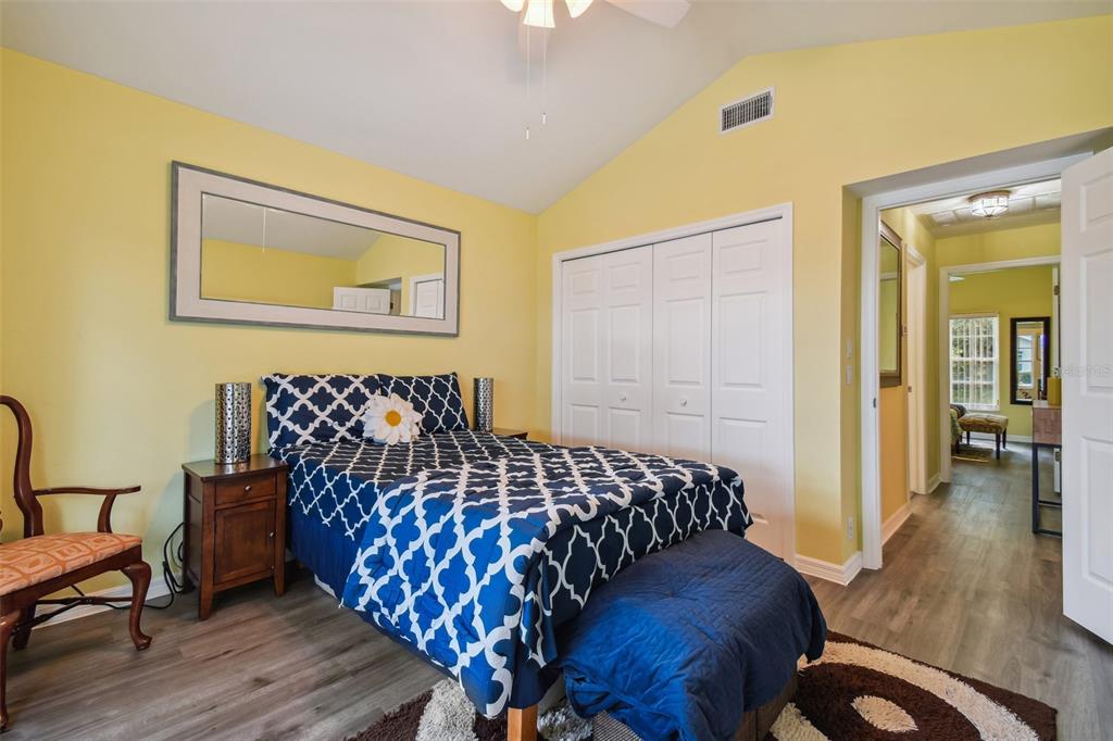 12728 Flamingo Parkway Spring Hill, FL 34610 - Photo 28 of 54 a bedroom with a bed and wooden floor