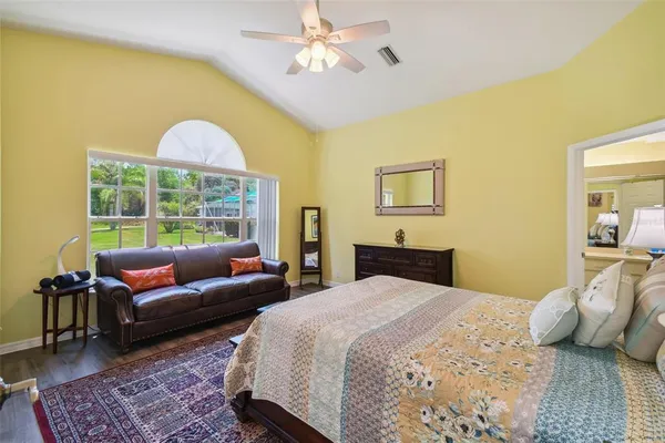 a bedroom with a bed a couch and a window