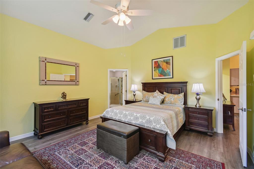 12728 Flamingo Parkway Spring Hill, FL 34610 - Photo 32 of 54 a bedroom with a bed and a chandelier