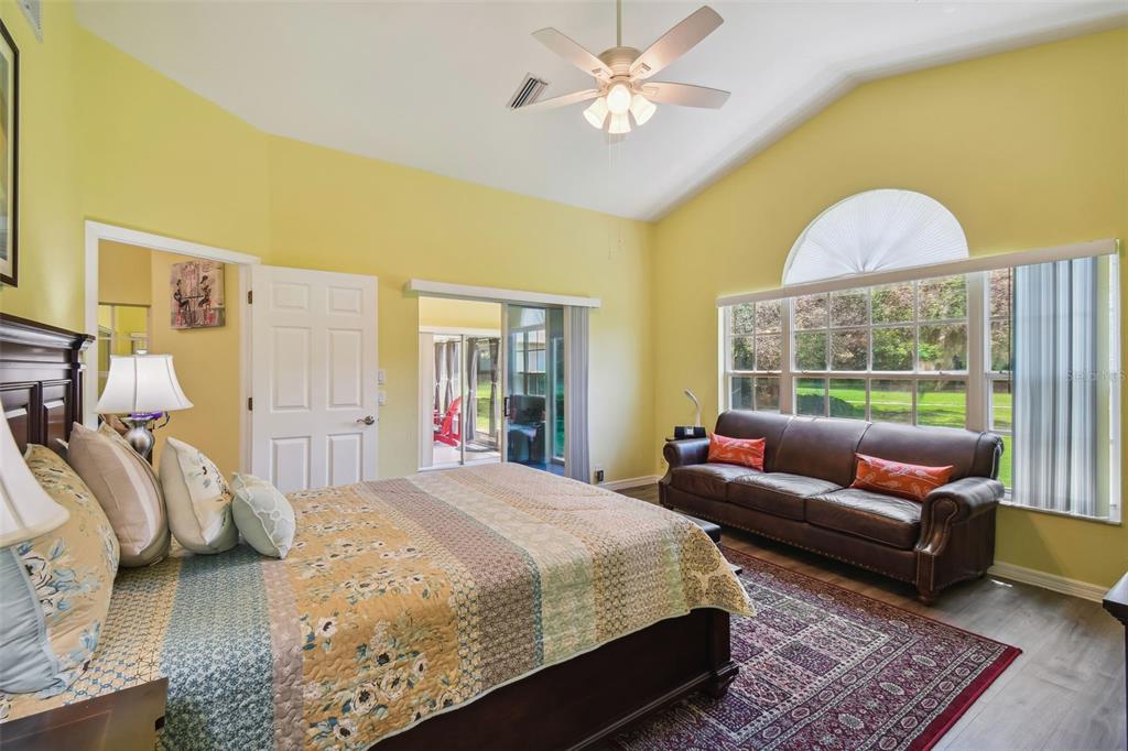 12728 Flamingo Parkway Spring Hill, FL 34610 - Photo 33 of 54 a bedroom with a bed a couch and a window