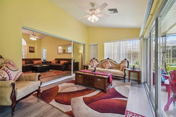a living room with furniture a rug and white walls