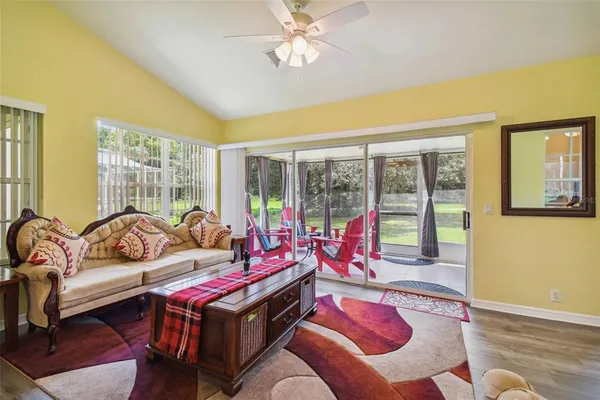 a living room with furniture and large windows