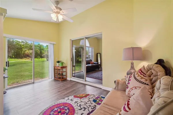 a living room with furniture and a floor to ceiling window