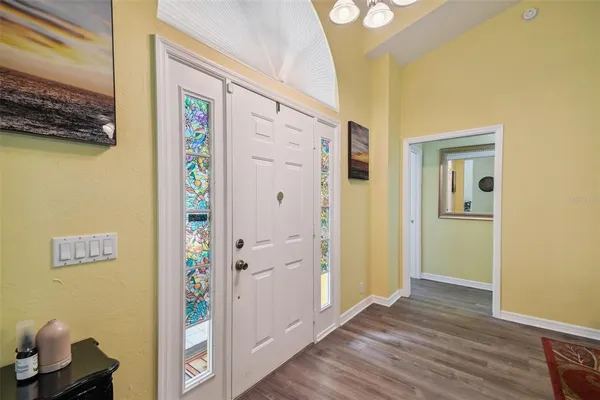 a view of a hallway with wooden floor and closet