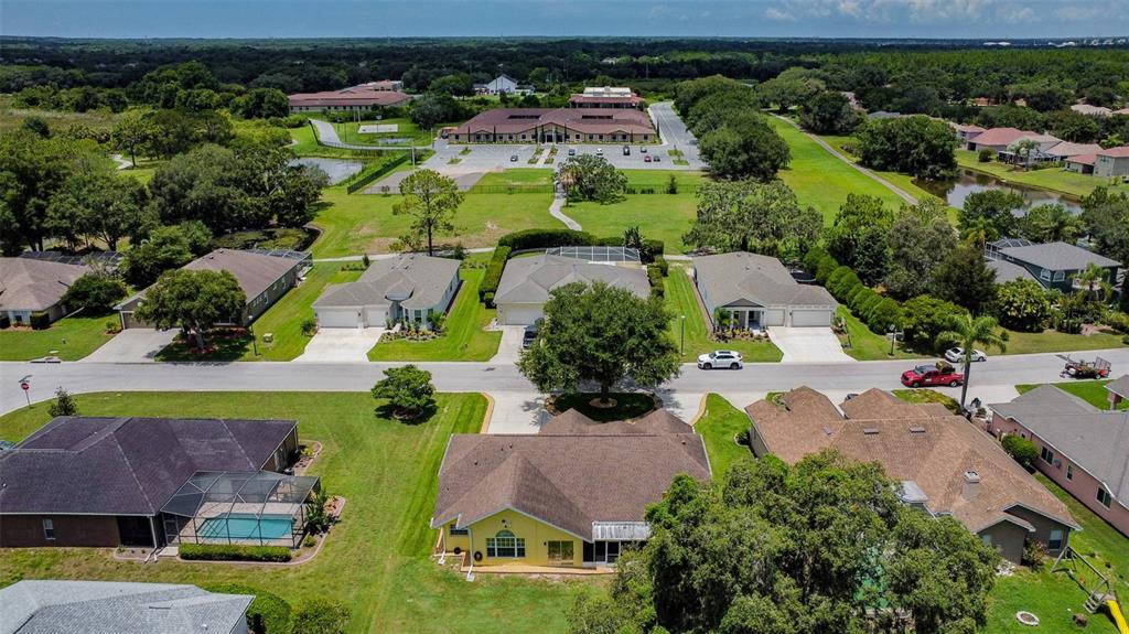 12728 Flamingo Parkway Spring Hill, FL 34610 - Photo 51 of 54 an aerial view of residential houses with outdoor space and trees