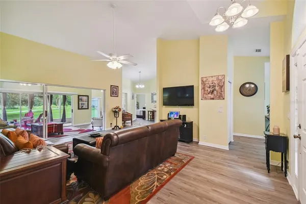 a living room with furniture a large window and a flat screen tv
