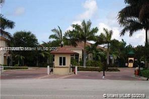 1925 Gardenia Court, Unit 1925 Riviera Beach, FL 33404 - Photo 1 of 10 a view of a house with a yard and palm trees