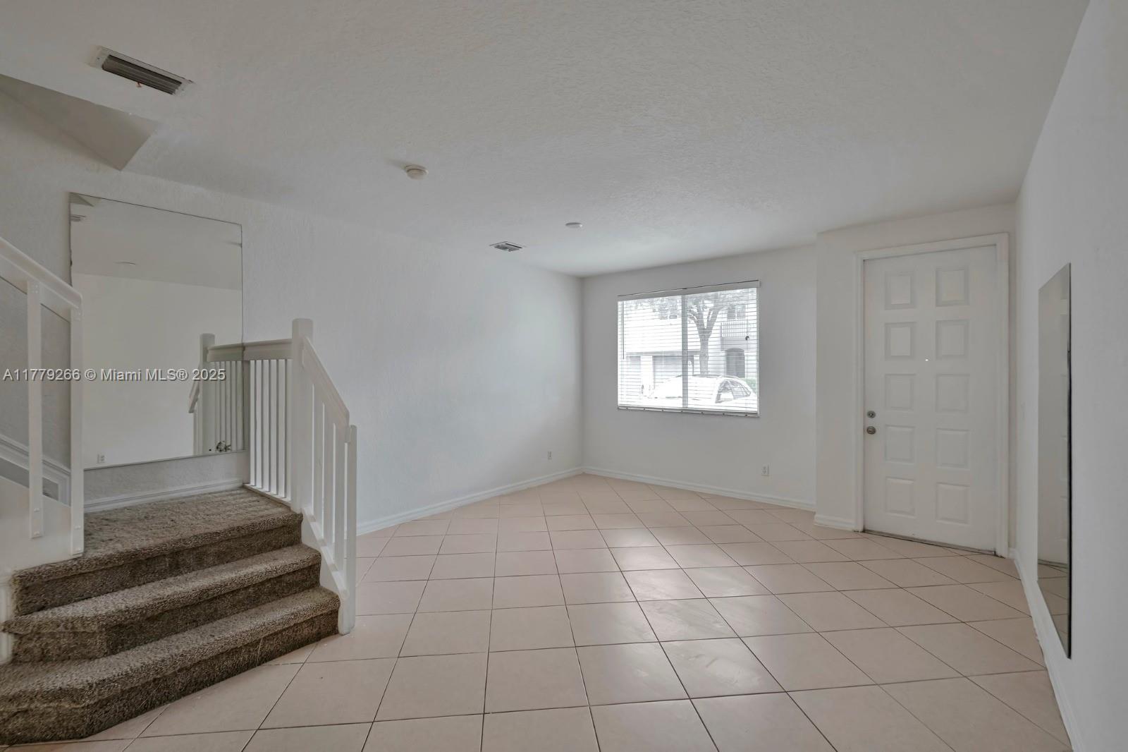 1925 Gardenia Court, Unit 1925 Riviera Beach, FL 33404 - Photo 4 of 10 a view of an entryway with a window